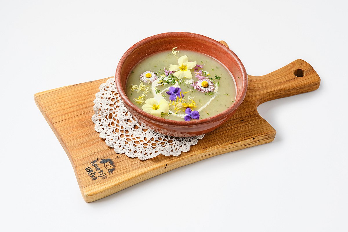 vegetable soup in a plate on a wooden board