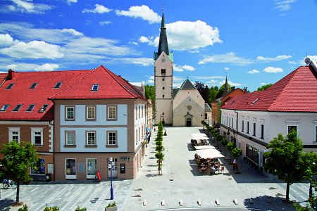 town square with a church in Slovenj Gradec