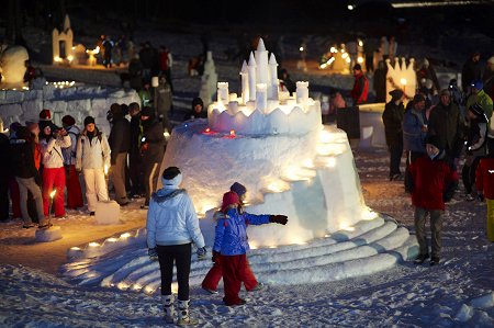 An icy castle surrounded by people